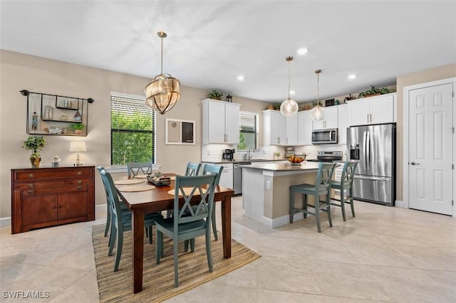 4012 E Hampton Cir, Alva, FL 33920 - dining area with healthy amount of natural light, a chandelier, light tile patterned flooring, and recessed lighting