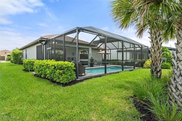 4012 E Hampton Cir, Alva, FL 33920 - rear view of house with stucco siding, a lawn, an outdoor pool, and a tile roof