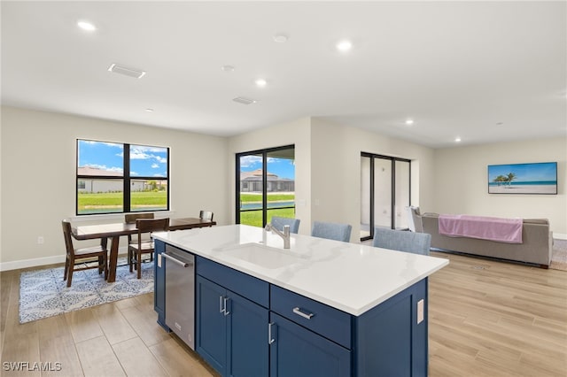 20676 Napa Loop, Estero, FL 33928 - kitchen featuring light wood-style floors, light countertops, recessed lighting, a center island with sink, and open floor plan