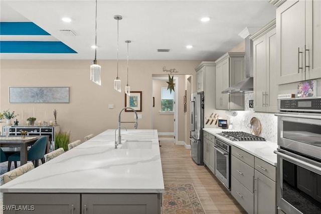 42274 Waterfront Way, Punta Gorda, FL 33982 - kitchen featuring stainless steel appliances, gray cabinetry, a kitchen island with sink, tasteful backsplash, and recessed lighting