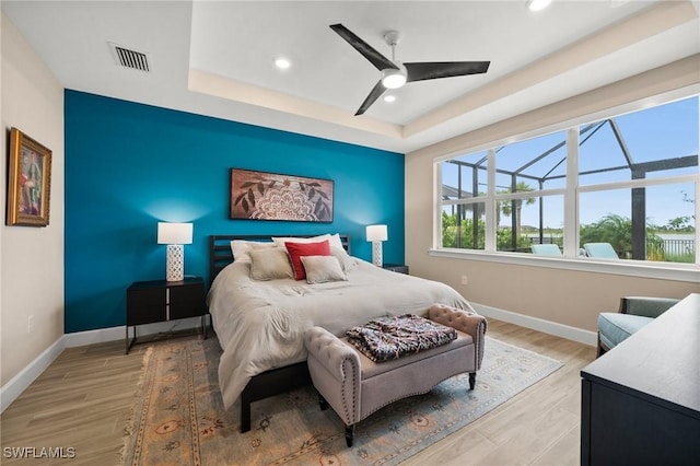42274 Waterfront Way, Punta Gorda, FL 33982 - bedroom with recessed lighting, a raised ceiling, light wood-style flooring, and a ceiling fan