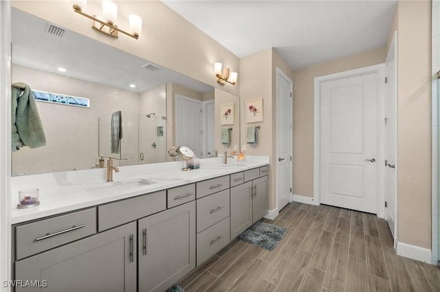 42274 Waterfront Way, Punta Gorda, FL 33982 - bathroom with double vanity, a shower stall, and wood finished floors