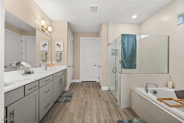 42274 Waterfront Way, Punta Gorda, FL 33982 - full bath featuring a garden tub, a shower stall, double vanity, and wood finish floors
