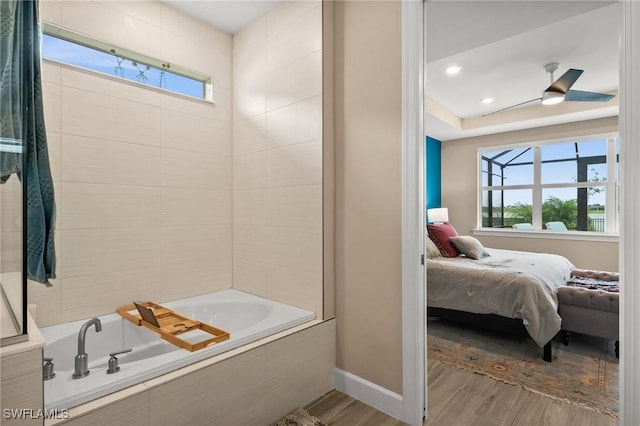42274 Waterfront Way, Punta Gorda, FL 33982 - ensuite bathroom featuring wood finished floors and tiled tub