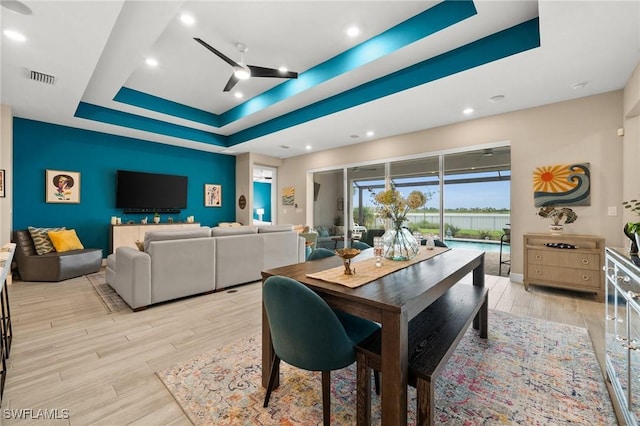 42274 Waterfront Way, Punta Gorda, FL 33982 - dining room featuring a raised ceiling, ceiling fan, light wood-style flooring, and recessed lighting