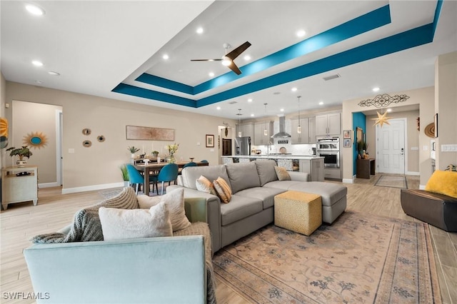 42274 Waterfront Way, Punta Gorda, FL 33982 - living area with a tray ceiling, ceiling fan, recessed lighting, and light wood finished floors