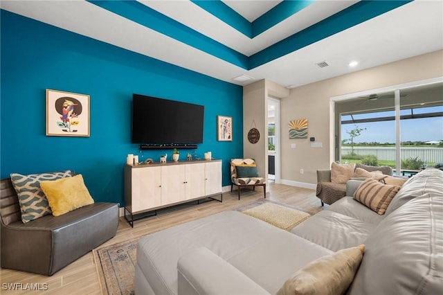 42274 Waterfront Way, Punta Gorda, FL 33982 - living area featuring wood finished floors, a raised ceiling, and recessed lighting