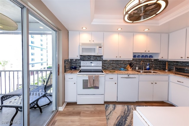 7000 Estero Blvd Unit 205, Fort Myers Beach, FL 33931 - kitchen with white appliances, a tray ceiling, plenty of natural light, backsplash, and crown molding