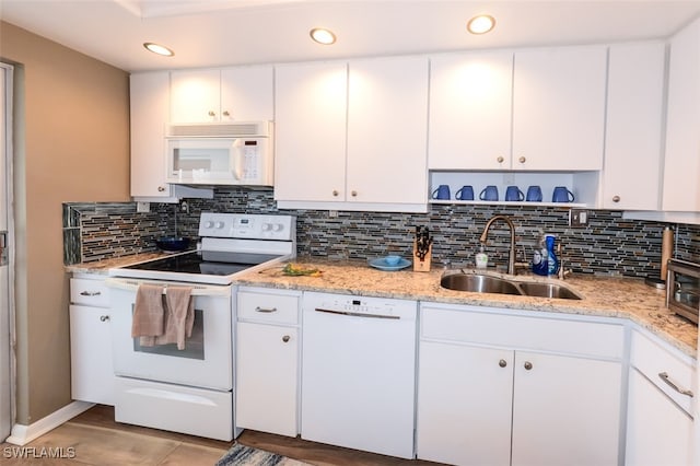 7000 Estero Blvd Unit 205, Fort Myers Beach, FL 33931 - kitchen featuring white appliances, decorative backsplash, recessed lighting, white cabinets, and light stone countertops
