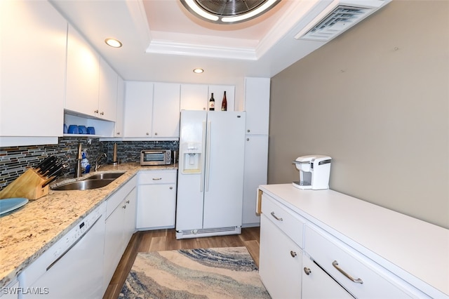 7000 Estero Blvd Unit 205, Fort Myers Beach, FL 33931 - kitchen with white appliances, a raised ceiling, wood finished floors, recessed lighting, and decorative backsplash