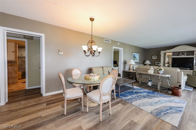 7000 Estero Blvd Unit 205, Fort Myers Beach, FL 33931 - dining space featuring a chandelier and wood finished floors