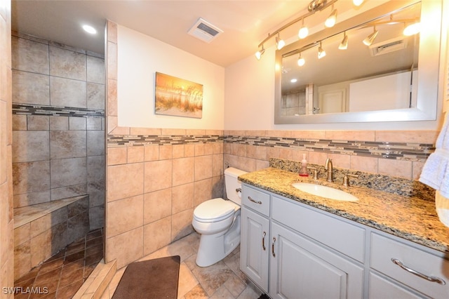 7000 Estero Blvd Unit 205, Fort Myers Beach, FL 33931 - full bath with vanity, walk in shower, tile walls, tile patterned floors, and a wainscoted wall