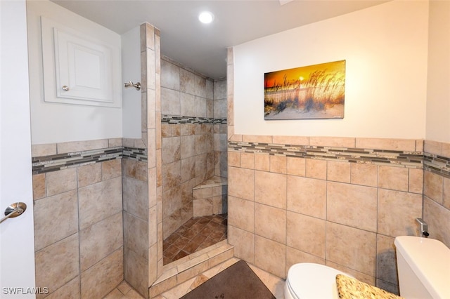 7000 Estero Blvd Unit 205, Fort Myers Beach, FL 33931 - bathroom with tile walls, tiled shower, recessed lighting, and wainscoting