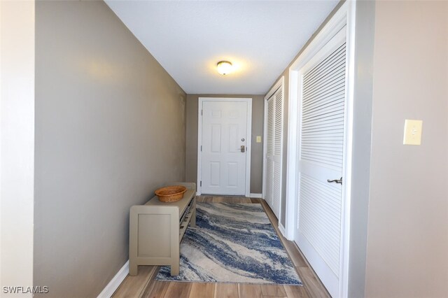 7000 Estero Blvd Unit 205, Fort Myers Beach, FL 33931 - doorway featuring wood finished floors and baseboards