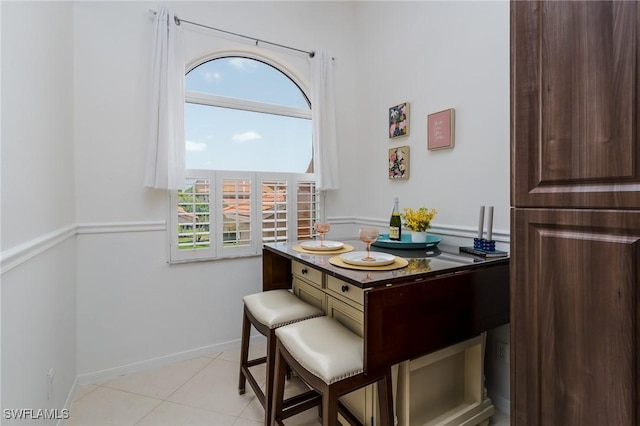 2525 Aspen Creek Ln Unit 202, Naples, FL 34119 - dining room with baseboards and light tile patterned floors