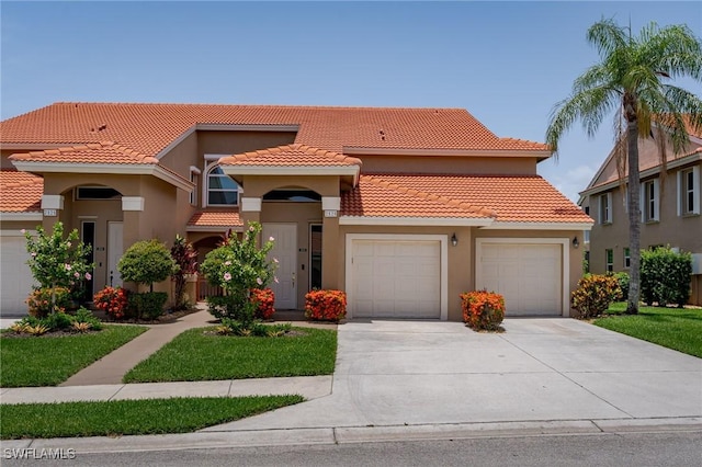 2525 Aspen Creek Ln Unit 202, Naples, FL 34119 - mediterranean / spanish home with concrete driveway, a garage, a tile roof, and stucco siding