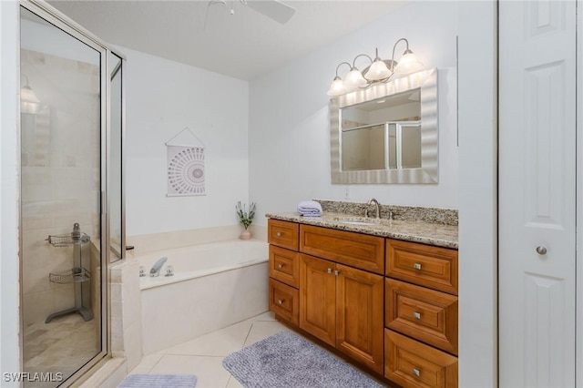 2525 Aspen Creek Ln Unit 202, Naples, FL 34119 - bathroom featuring a stall shower, vanity, a bath, ceiling fan, and tile patterned floors