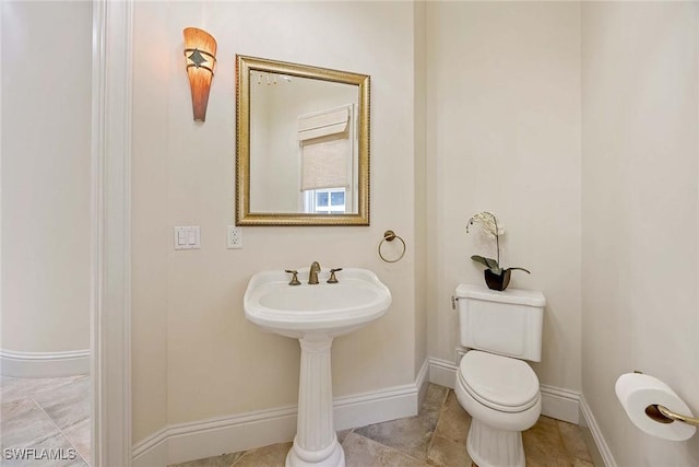 6912 Anthurium Ln, Naples, FL 34113 - half bathroom featuring toilet and baseboards