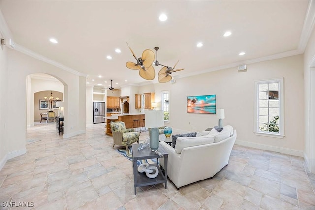 6912 Anthurium Ln, Naples, FL 34113 - living area featuring arched walkways, a ceiling fan, crown molding, stone tile floors, and recessed lighting