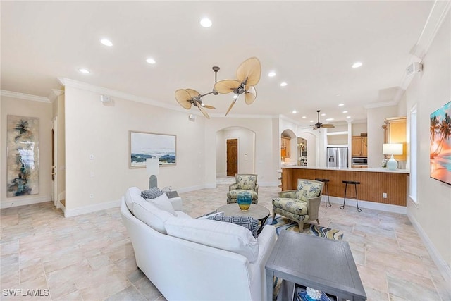 6912 Anthurium Ln, Naples, FL 34113 - living area featuring arched walkways, a ceiling fan, ornamental molding, recessed lighting, and light stone finish flooring