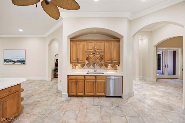 6912 Anthurium Ln, Naples, FL 34113 - kitchen with stainless steel dishwasher, arched walkways, light countertops, a ceiling fan, and ornamental molding