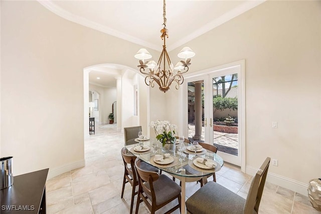6912 Anthurium Ln, Naples, FL 34113 - dining space featuring arched walkways, a chandelier, and ornamental molding