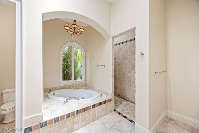 6912 Anthurium Ln, Naples, FL 34113 - bathroom with a whirlpool tub, a chandelier, a tile shower, and tile patterned floors