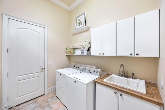 6912 Anthurium Ln, Naples, FL 34113 - washroom featuring washing machine and dryer, cabinet space, and crown molding