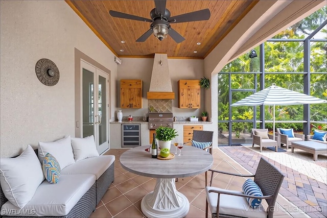 6912 Anthurium Ln, Naples, FL 34113 - view of patio featuring wine cooler, an outdoor living space, a lanai, and french doors