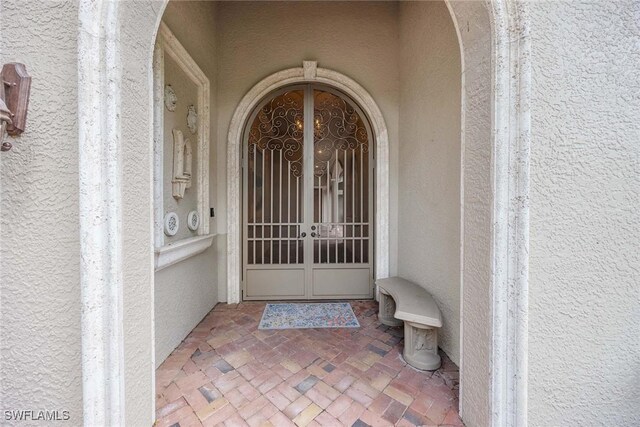 6912 Anthurium Ln, Naples, FL 34113 - entrance to property with stucco siding