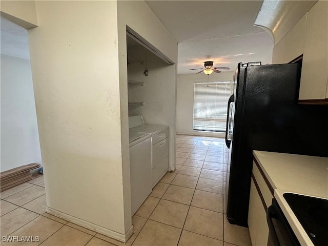 1224 Commonwealth Cir Unit N-203, Naples, FL 34116 - kitchen featuring washer and dryer, a ceiling fan, light tile patterned flooring, white cabinetry, and stove