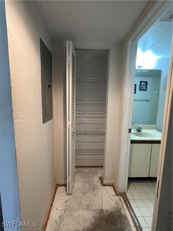1224 Commonwealth Cir Unit N-203, Naples, FL 34116 - hallway featuring electric panel and a sink