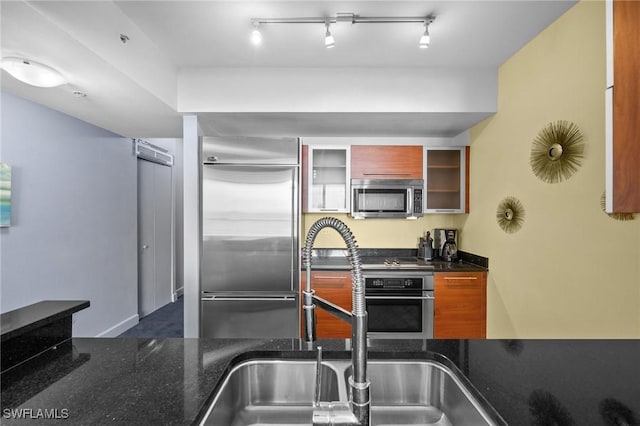 3000 Oasis Grand Blvd Unit 906, Fort Myers, FL 33916 - kitchen featuring stainless steel appliances, glass insert cabinets, and dark stone countertops
