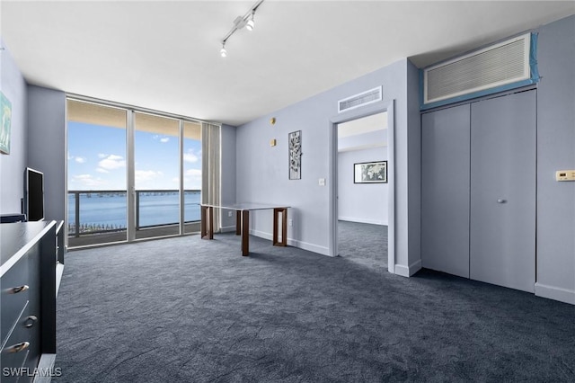3000 Oasis Grand Blvd Unit 906, Fort Myers, FL 33916 - unfurnished bedroom with dark colored carpet, access to exterior, and multiple windows