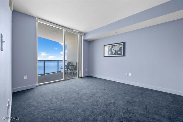 3000 Oasis Grand Blvd Unit 906, Fort Myers, FL 33916 - spare room featuring dark colored carpet, floor to ceiling windows, and a water view