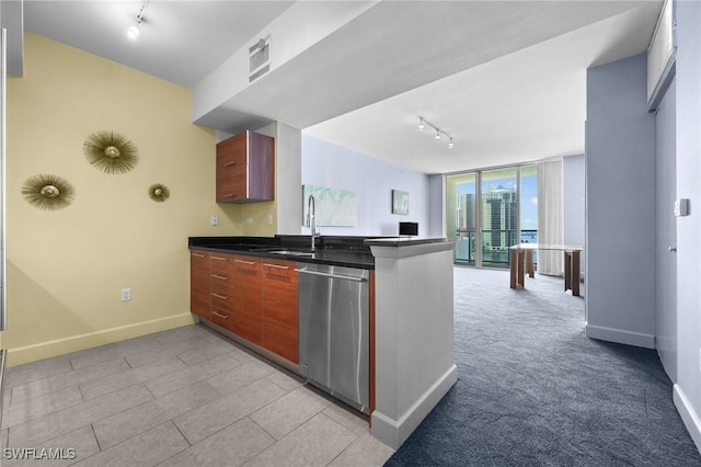 3000 Oasis Grand Blvd Unit 906, Fort Myers, FL 33916 - kitchen with rail lighting, stainless steel dishwasher, dark countertops, and a peninsula