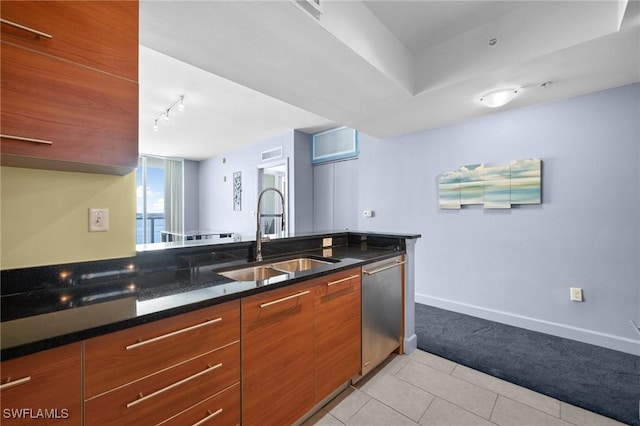3000 Oasis Grand Blvd Unit 906, Fort Myers, FL 33916 - kitchen with stainless steel dishwasher, light colored carpet, light tile patterned flooring, modern cabinets, and track lighting