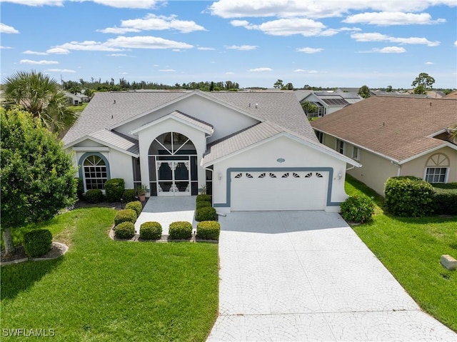 17770 Pineapple Palm Ct, North Fort Myers, FL 33917 - single story home featuring an attached garage, decorative driveway, a front lawn, and stucco siding