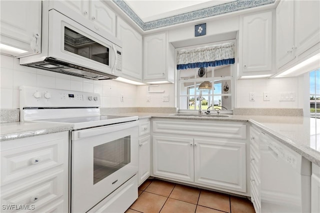 17770 Pineapple Palm Ct, North Fort Myers, FL 33917 - kitchen featuring white appliances, backsplash, white cabinets, and light tile patterned flooring
