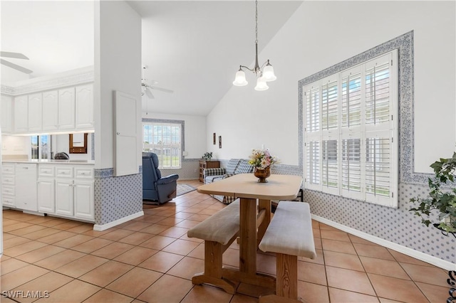 17770 Pineapple Palm Ct, North Fort Myers, FL 33917 - dining space featuring a ceiling fan, wallpapered walls, high vaulted ceiling, a chandelier, and light tile patterned floors
