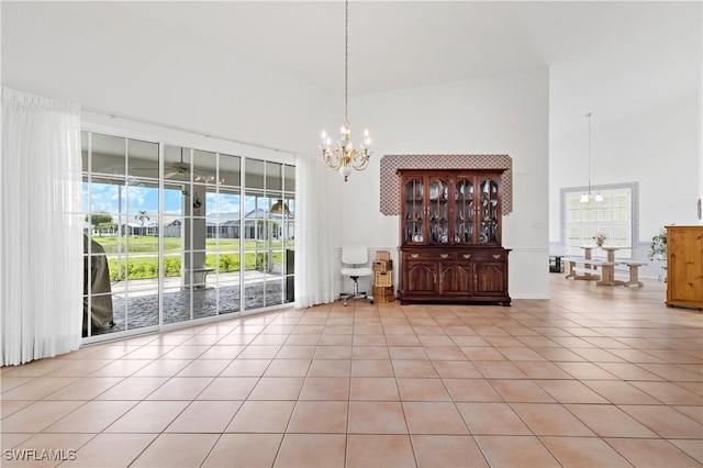 17770 Pineapple Palm Ct, North Fort Myers, FL 33917 - dining room featuring a chandelier, a high ceiling, and light tile patterned floors