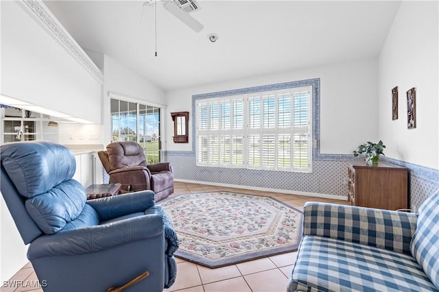 17770 Pineapple Palm Ct, North Fort Myers, FL 33917 - living area with healthy amount of natural light, a wainscoted wall, tile patterned flooring, vaulted ceiling, and a ceiling fan