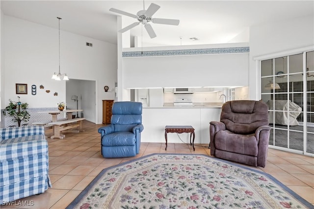 17770 Pineapple Palm Ct, North Fort Myers, FL 33917 - tiled living room with a towering ceiling, a ceiling fan, and a chandelier