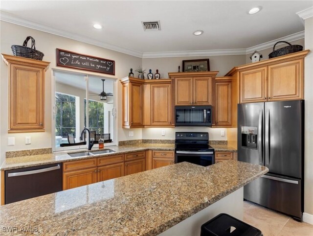 20838 Torre Del Lago St, Estero, FL 33928 - kitchen with black appliances, light stone countertops, crown molding, recessed lighting, and brown cabinetry