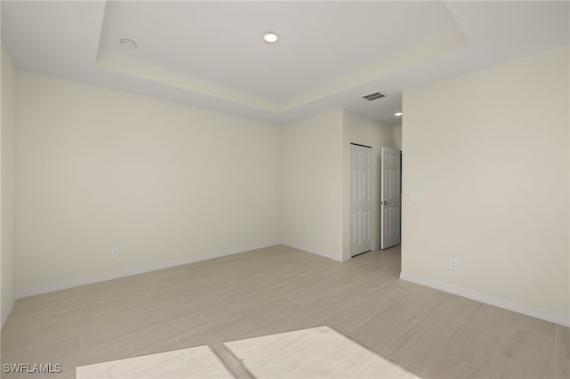 3211 8th St W, Lehigh Acres, FL 33971 - empty room featuring a tray ceiling, recessed lighting, and a smoke detector