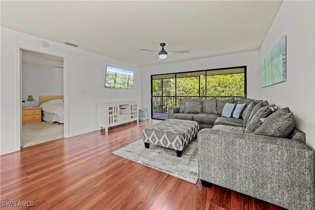240 Pebble Beach Cir Unit F206, Naples, FL 34113 - living room with wood finished floors and a ceiling fan