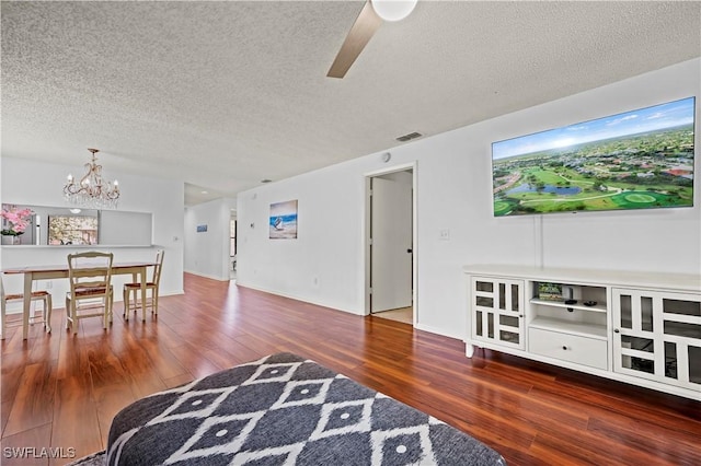 240 Pebble Beach Cir Unit F206, Naples, FL 34113 - living area with a textured ceiling, wood finished floors, a chandelier, and a ceiling fan