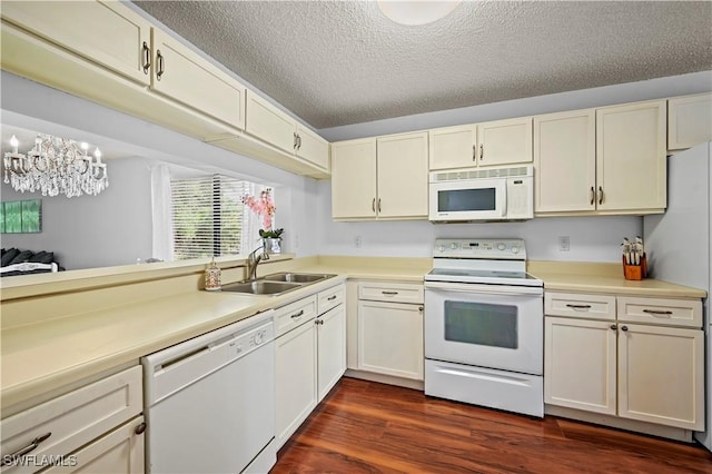 240 Pebble Beach Cir Unit F206, Naples, FL 34113 - kitchen featuring white appliances, light countertops, a textured ceiling, dark wood-type flooring, and a chandelier