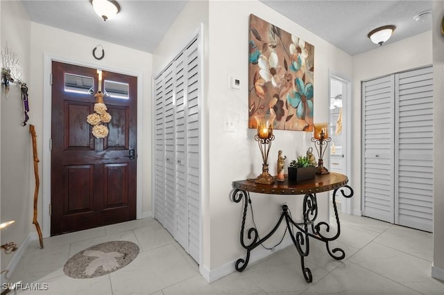 4251 Island Cir Unit 3, Fort Myers, FL 33919 - entryway featuring a textured ceiling and light tile patterned flooring