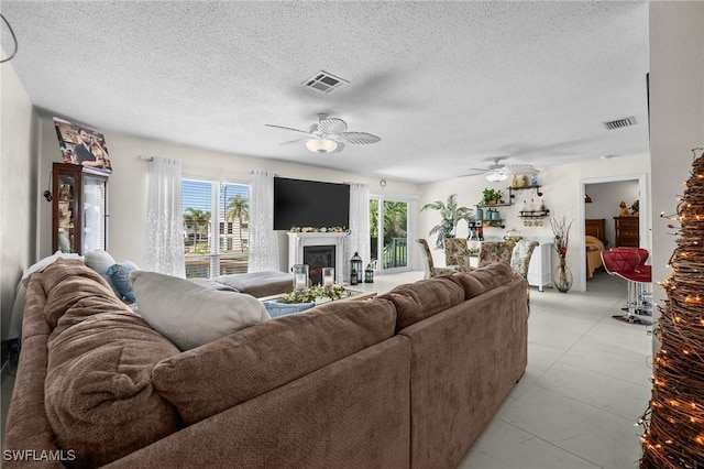 4251 Island Cir Unit 3, Fort Myers, FL 33919 - living room with a glass covered fireplace, a ceiling fan, and a textured ceiling